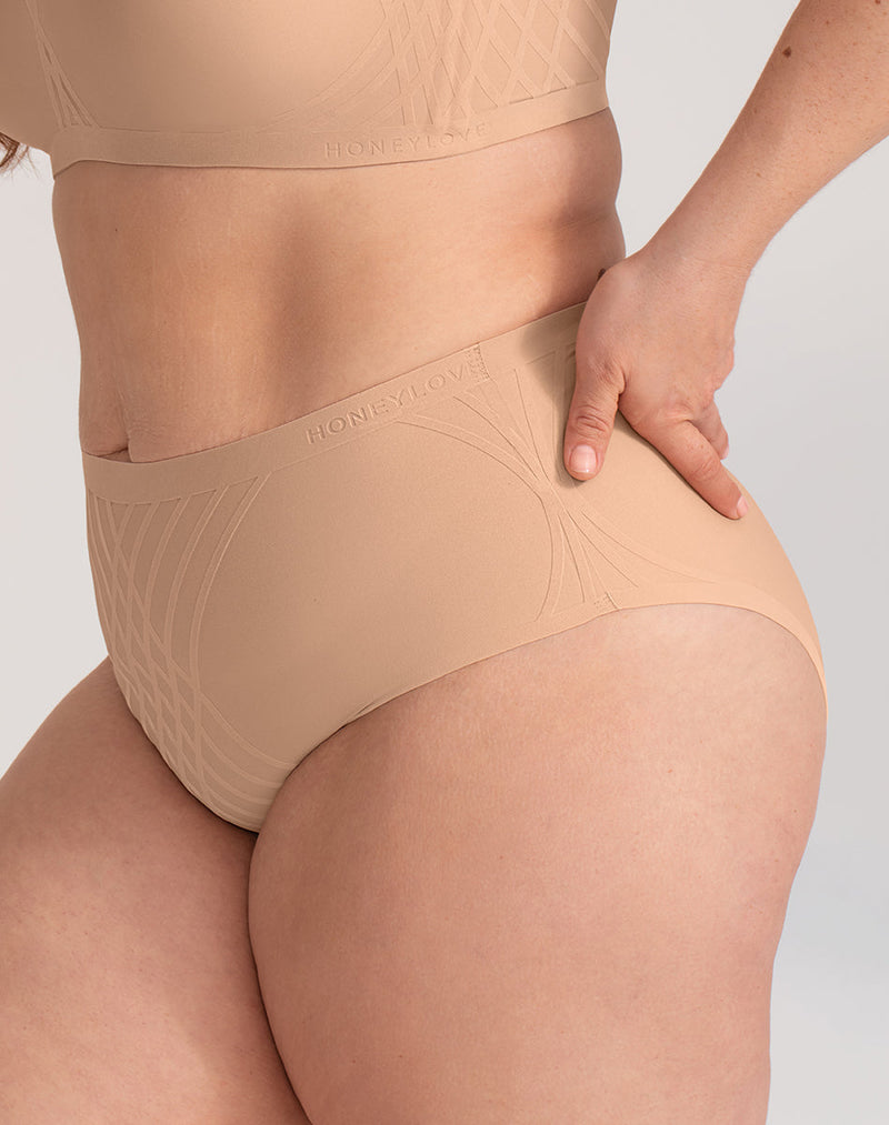 Model Brianna wearing Silhouette Brief in size Plus size one and color Sand, seen from the Side