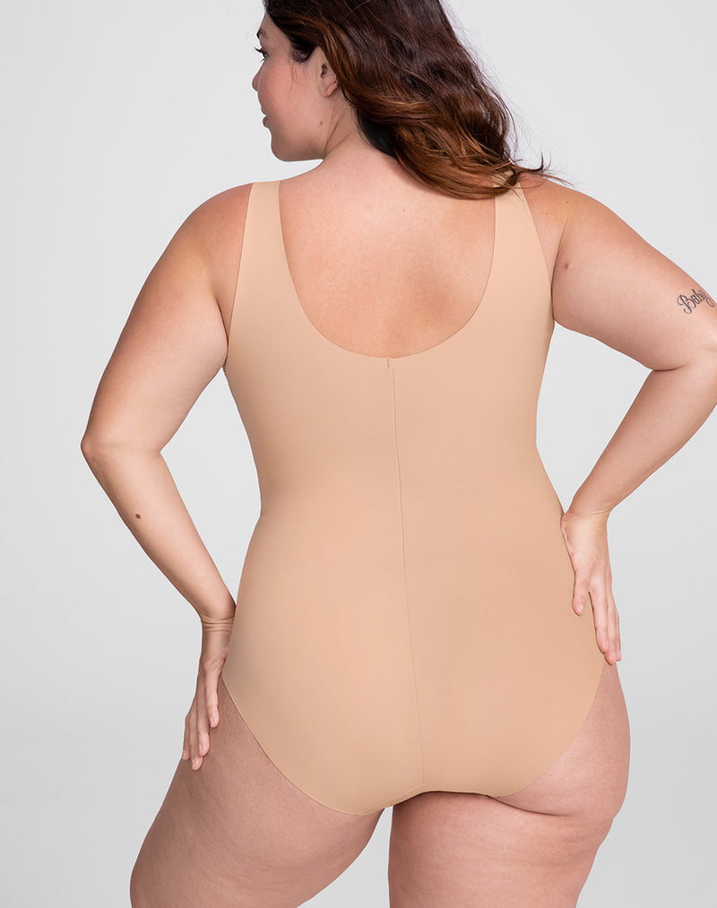Model Natalie wearing Tank Bodysuit in size Plus size one and color Sand, seen from the Back
