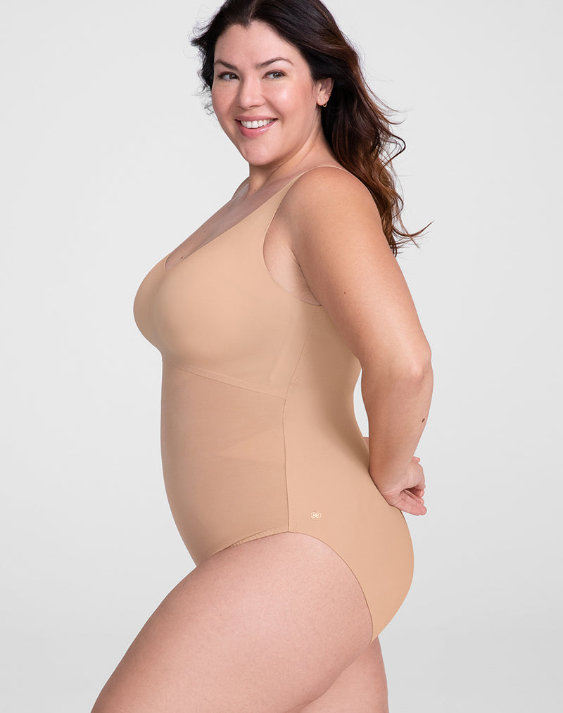 Model Natalie wearing Tank Bodysuit in size Plus size one and color Sand, seen from the Side