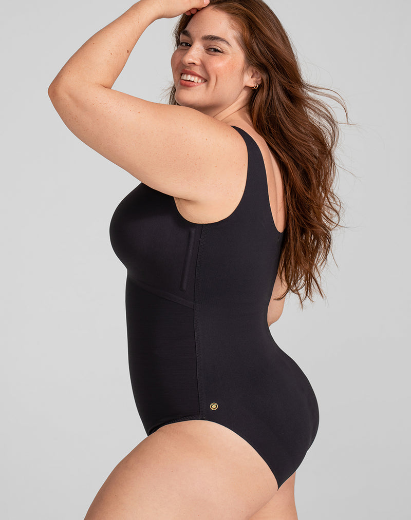 Model Brianna wearing Tank Bodysuit in size Plus size one and color Vamp, seen from the Side