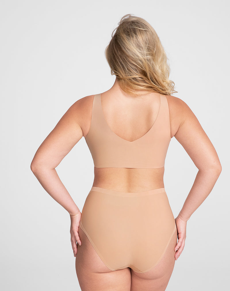 Model McCallah wearing V-Neck Bra in size Large and color Sand, seen from the Back