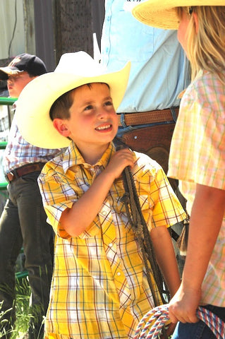 young boy, custer ranch rodeo, cowboys, montana living