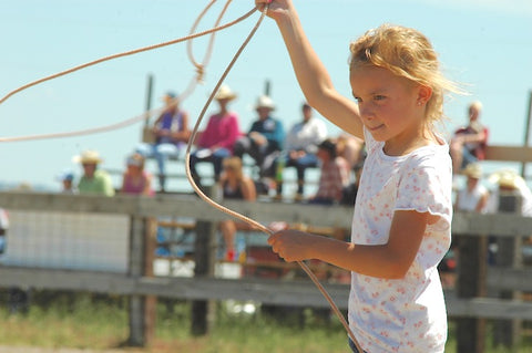 girl twirls rope at custer ranch rodeo in custer, montana, montana living cowboys and cowgirls