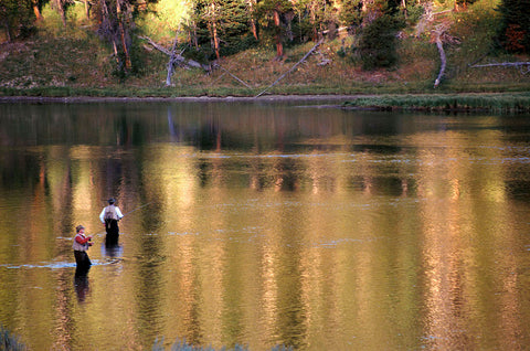 two flyfishers in river, fly fishing yellowstone national park, montana living
