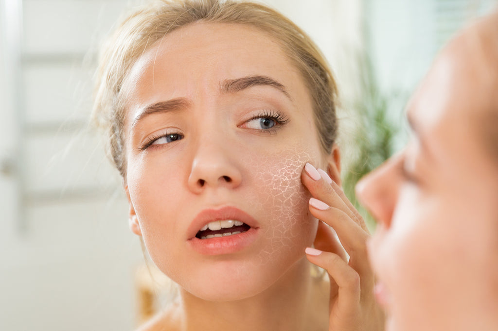 woman inspecting dry skin