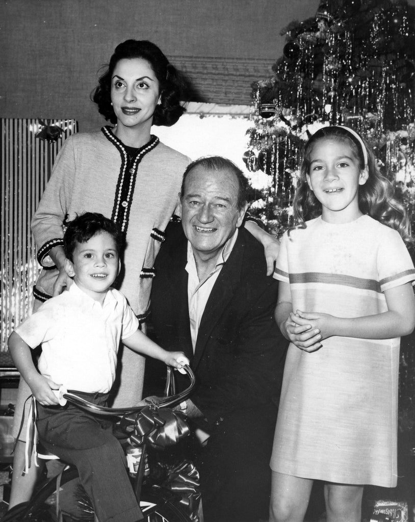 John Wayne with wife Pilar and children at Christmas