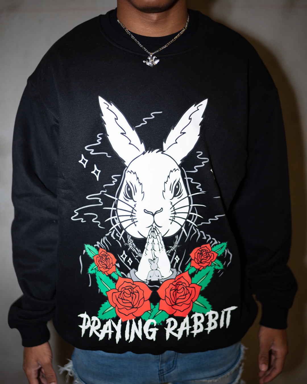 black crew neck with praying rabbit design and red roses