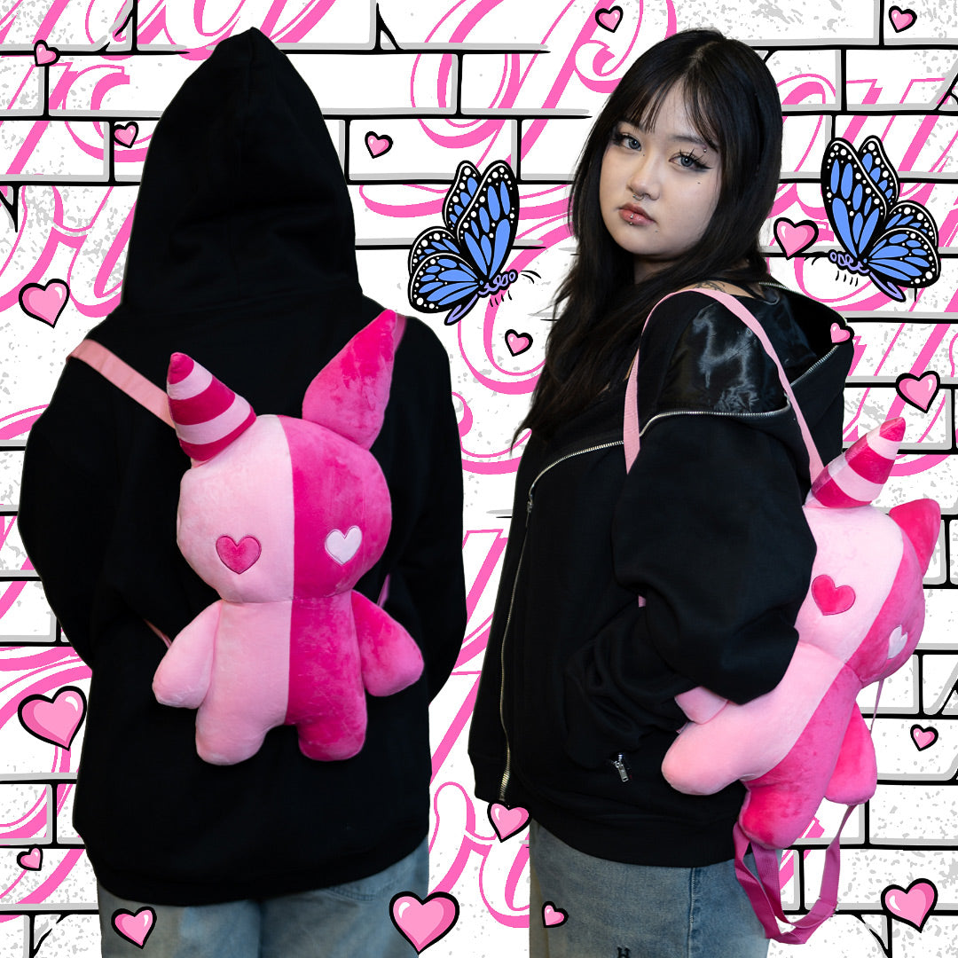 model wearing pink rabbit plush backpack with heart eyes