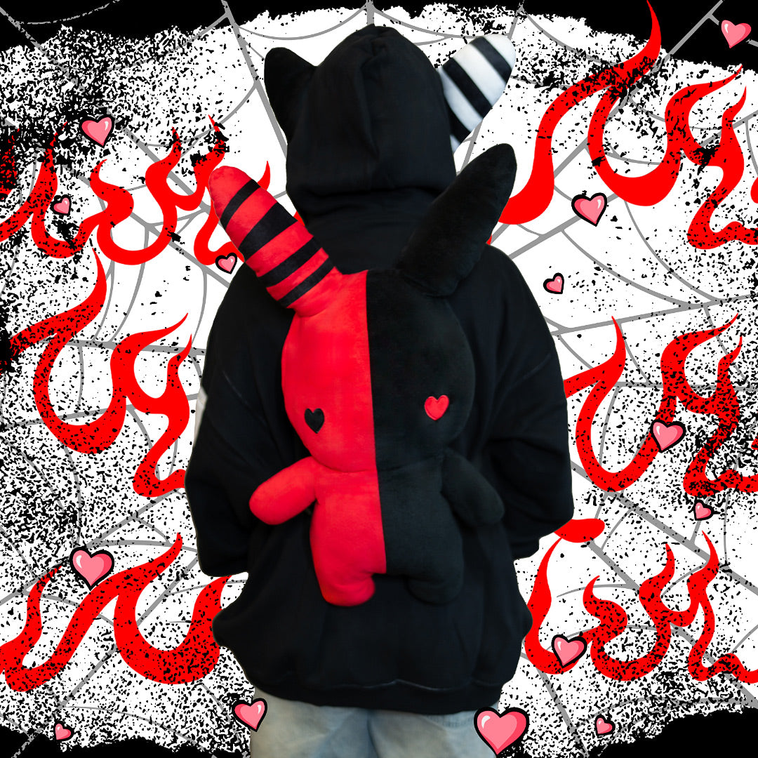 model wearing a black and red rabbit plush backpack with heart eyes
