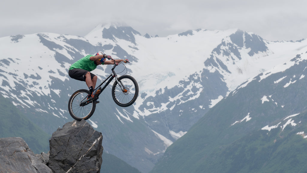 Kenny Belaey doing trials in the mountains on a dangerous rock