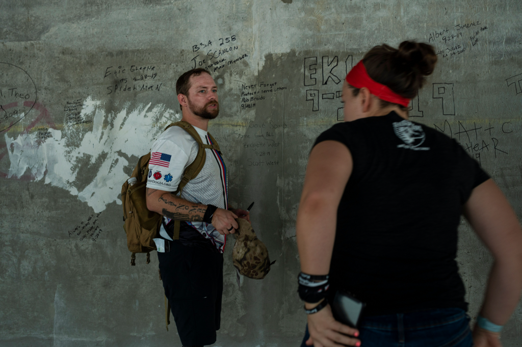 Double Amputee Scott West signing the wall