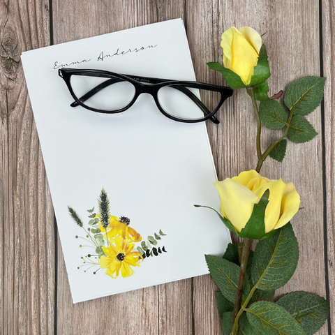 Stationery and glasses with yellow flowers