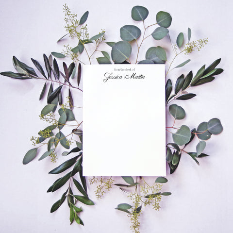 pretty stationery resting on top of eucalyptus leaves