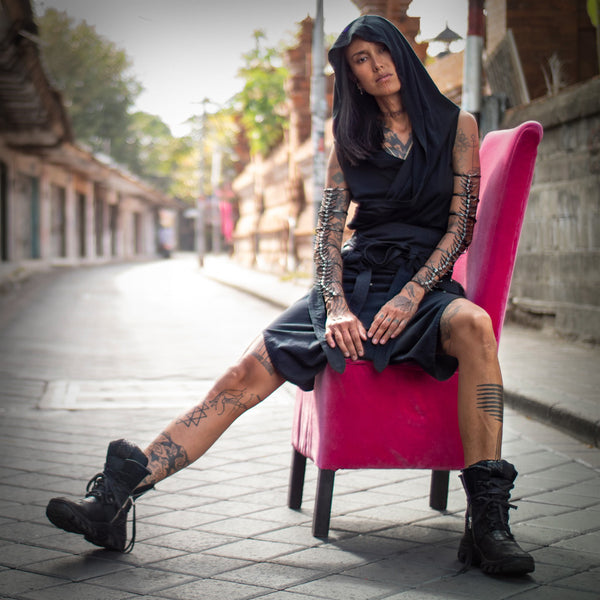 Fa wearing psylo fashion unisex clothing sitting on armchair in middle of empty street