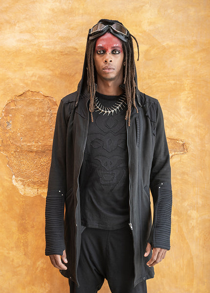 Dune Outfits inspired by galactic rugged elegance. Him: Mask Sleeveless Hoodie, Osaka Long Coat, Eleven Unisex Pants, and the Centipede Monster Necklace by Costume Therapy