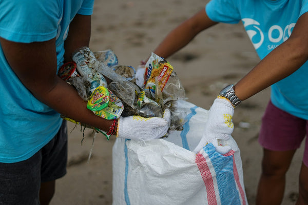 beach clean-up (photo by OCG Saving The Ocean via Unsplash)