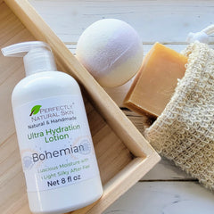 Perfectly Natural Skin's Bohemian Lotion displayed with the same scent's bubble bath bomb and bar soap in a sisal soap saver