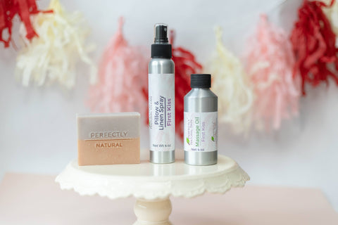cake plate display of First Kiss scented soap, Pillow Spray and Massage oil by Perfectly Natural Soap