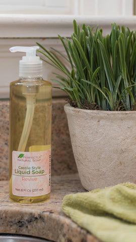 revive castile liquid soap sitting next to sink