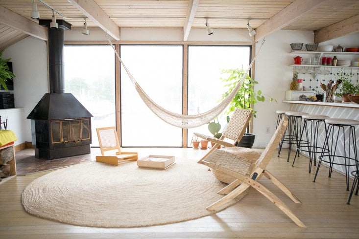 indoor hammock chair by fireplace