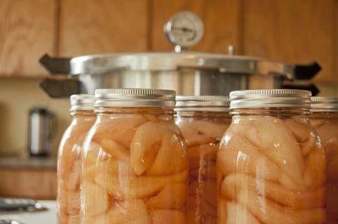 Harvested pears and apples preserved in jars.