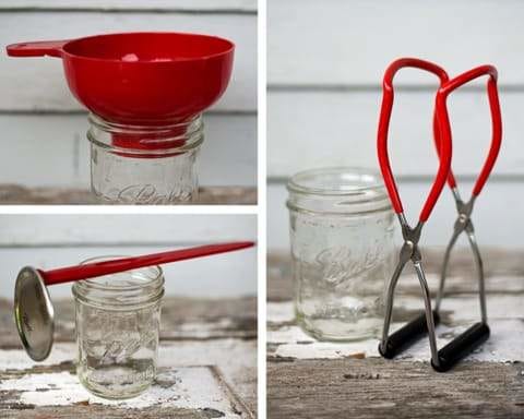 Red canning utensils with natural wooden background.