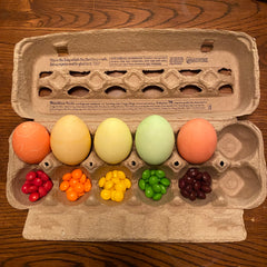 skittles and dyed easter eggs in an egg carton
