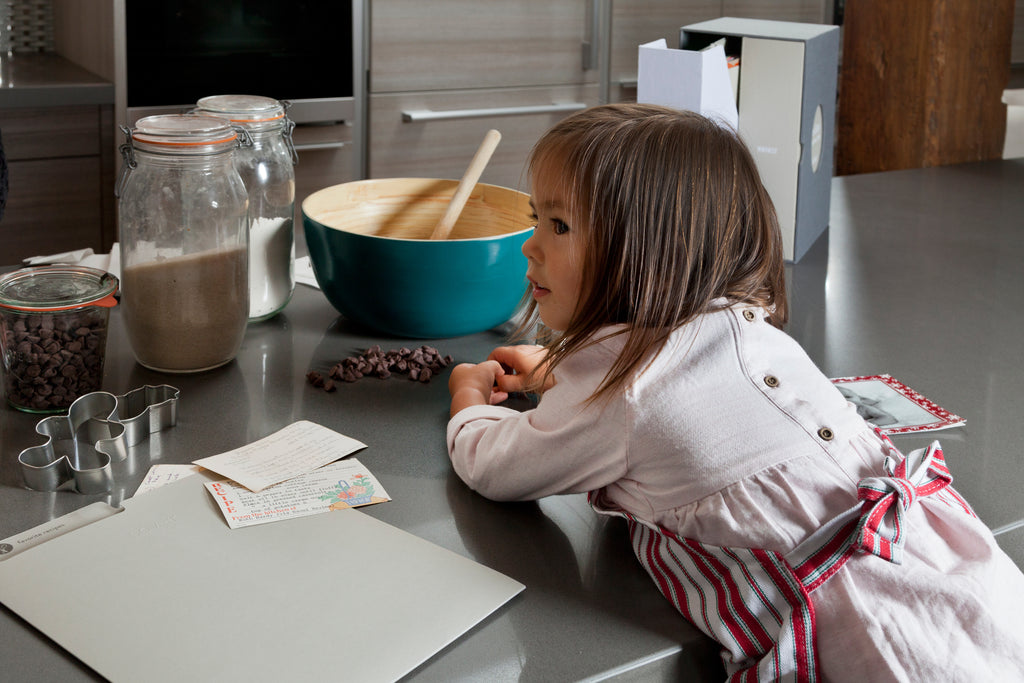 little girl on a kitchen counter redy to bake