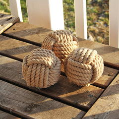 3 tan monkey fist balls on table