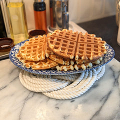 white trivet and plate of waffles