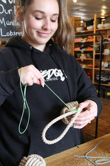 tying the finishing whip on a dog toy