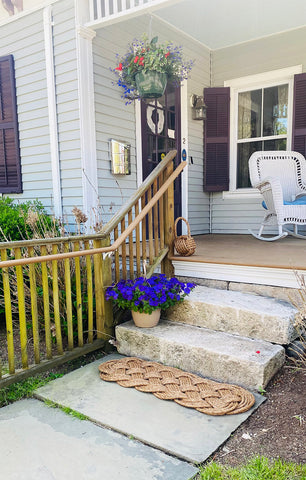 prolong manila door mat on porch steps of Mermaid Inn in Mystic
