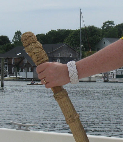 Turk's Head knot on wrist and another on the tiller