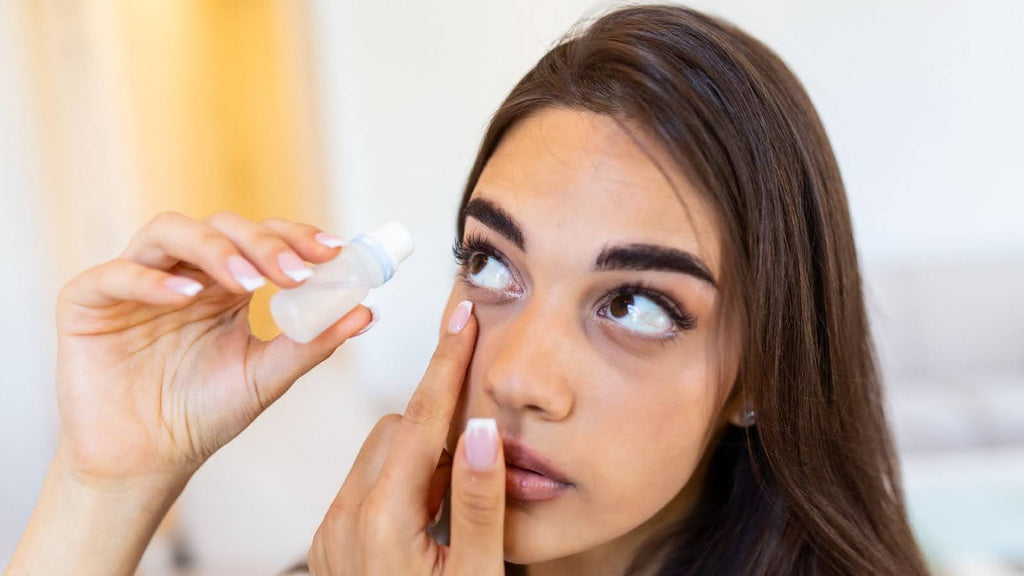 Girl putting drops in her eye