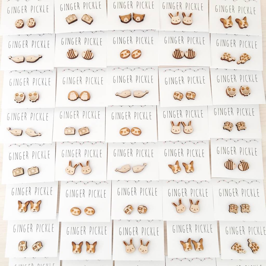 An image featuring lots of Jade's earring designs all lined up neatly. There are whales, dogs, bees, sloths and cameras.