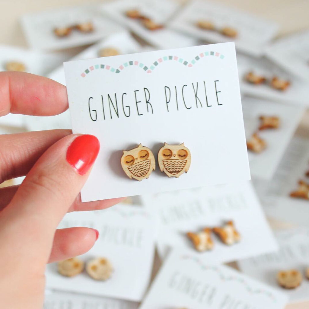 An image of Jade's original owl earrings, mounted on a branded Ginger Pickle card.