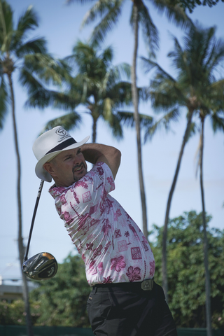 Rory Sabbatini wearing OGA polo shirt and swinging golf club