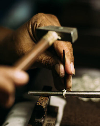 Hands working with jewellery tools to handmade jewellery