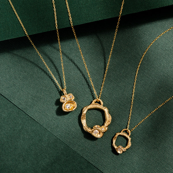 White Topaz and Gold Vermeil Necklace Collection. Featuring three necklaces two eternity necklaces and one pendant inspired by nature