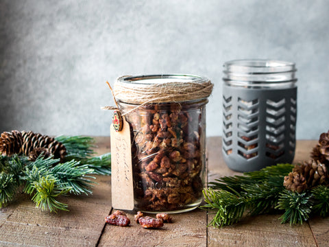 Candied pecans in a Mason jar decorated with twine and a homemade gift tag. 