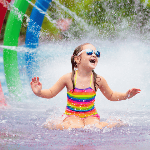 Young Girl Enjoying Splash Pad in Summer