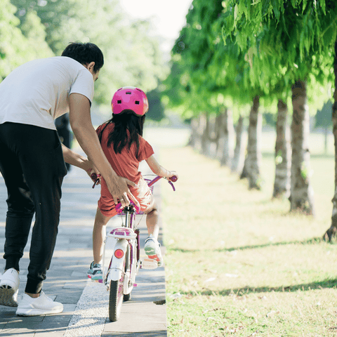 Mom Teaching Child to Ride Bike