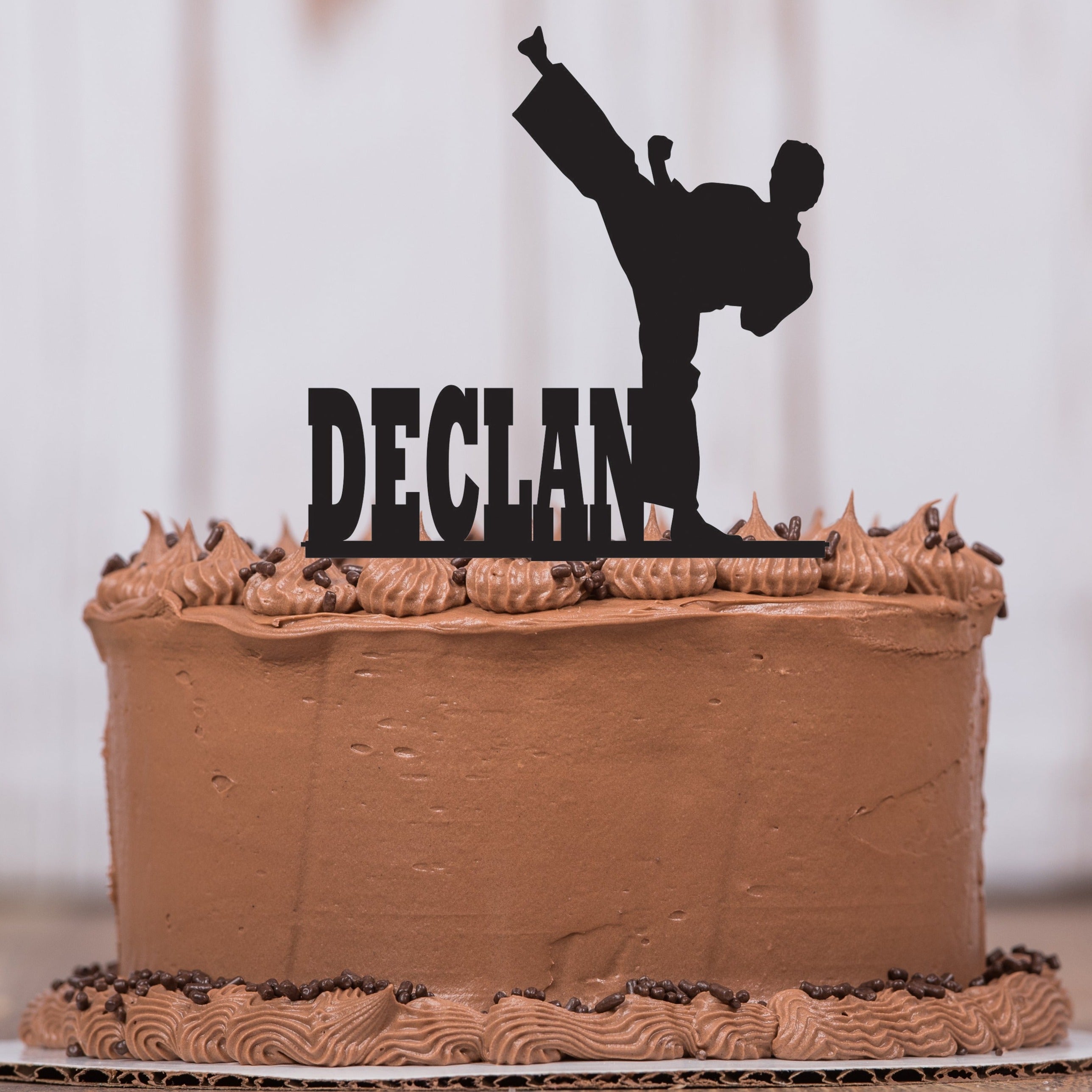 Birthday cake decorated with karate silhouette, in blue and white on gray  background Stock Photo - Alamy