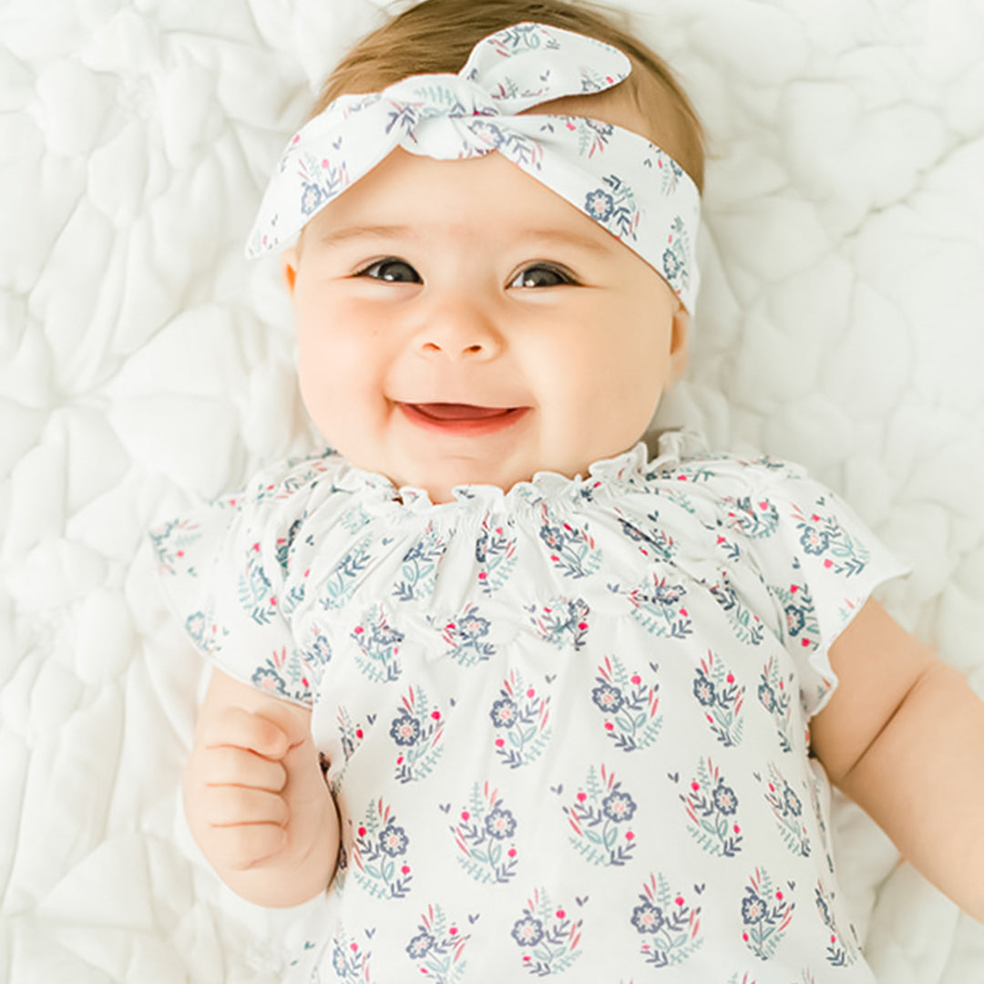 smiling baby wearing a headband