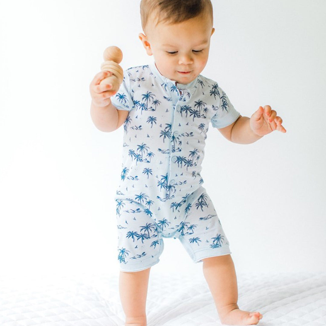 baby standing and playing with a toy