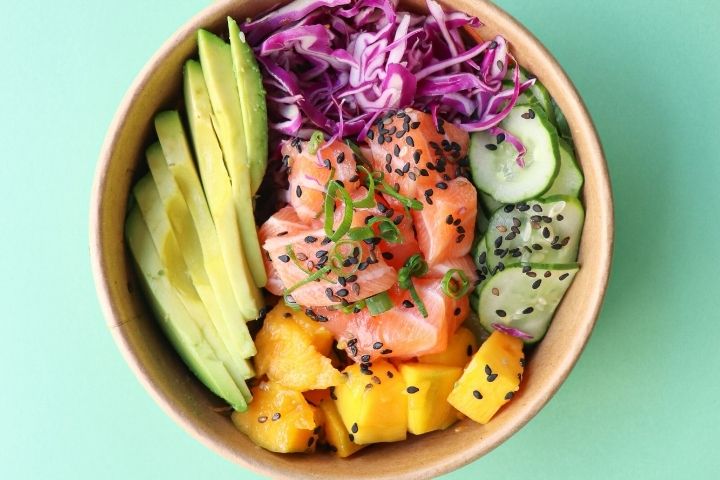 A photo of delicious vegetables in a bowl on a green background