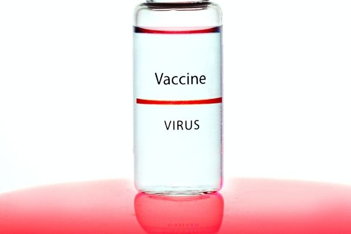 A vaccine vial on a red background