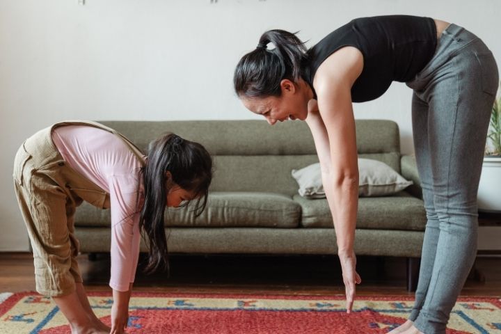 A woman exercising with her daughter