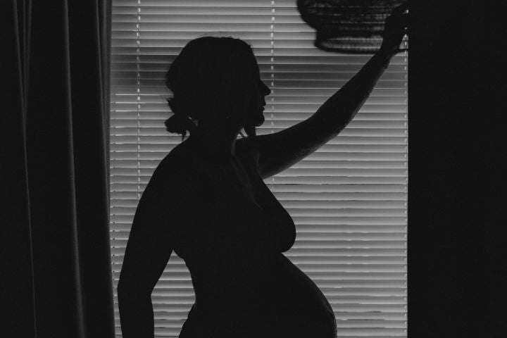 Black and white photo of a pregnant woman