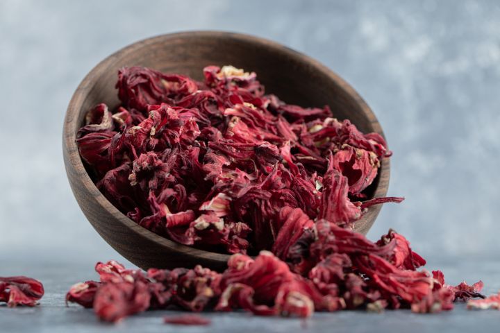 Dry Hibiscus Tea in Wooden Bowl